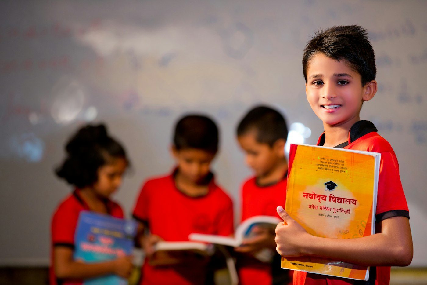 A pupil holding a school exam guide in class