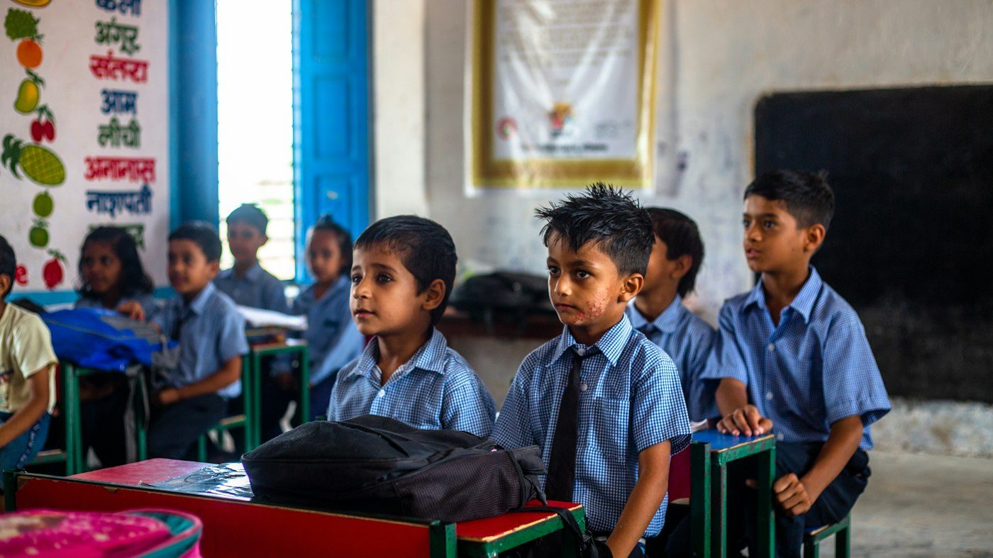 A classroom of children in uniform at their desks in an Indian school