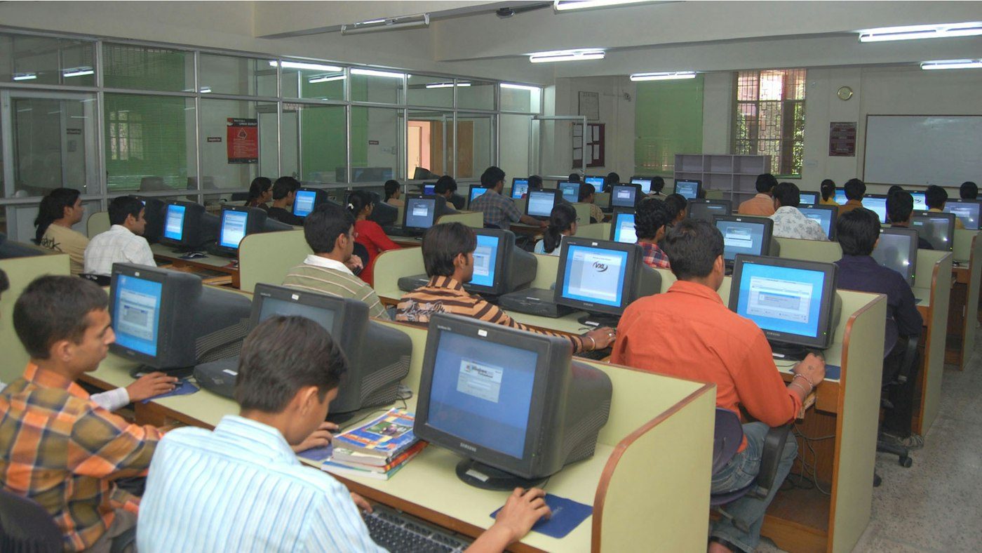 Trainees at computers in a training room