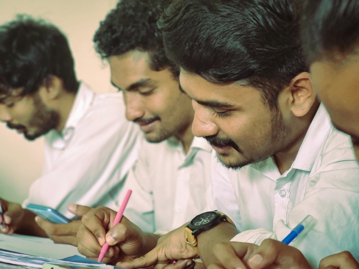 Trainees writing at their desks during a session